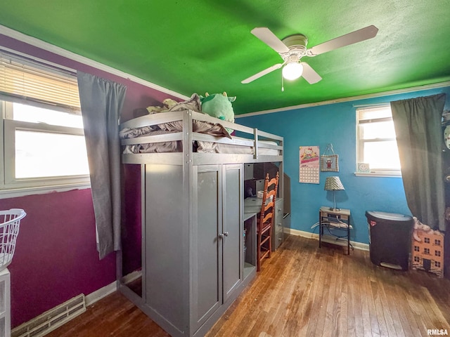 bedroom with ceiling fan and hardwood / wood-style flooring