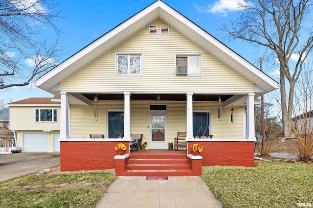 bungalow with covered porch and a garage