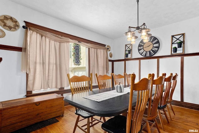 dining area featuring hardwood / wood-style flooring, a chandelier, and a textured ceiling