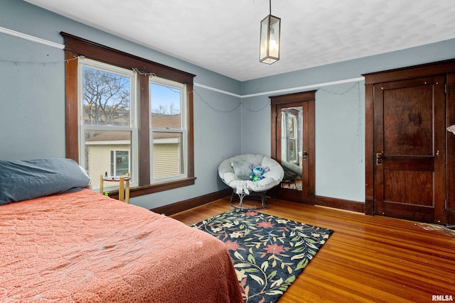 bedroom featuring a textured ceiling and dark hardwood / wood-style floors