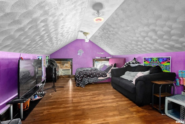 playroom with wood-type flooring, a textured ceiling, and lofted ceiling