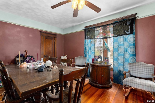 dining space with hardwood / wood-style flooring and ceiling fan