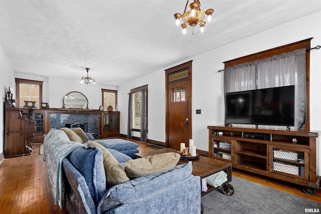 living room with a chandelier, hardwood / wood-style floors, and a textured ceiling