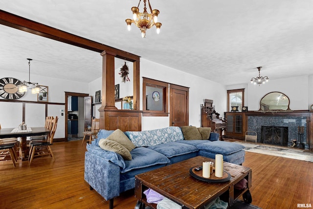 living room with hardwood / wood-style flooring, a textured ceiling, and a notable chandelier