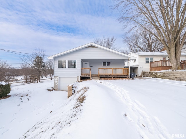 view of front of property with a wooden deck and a garage