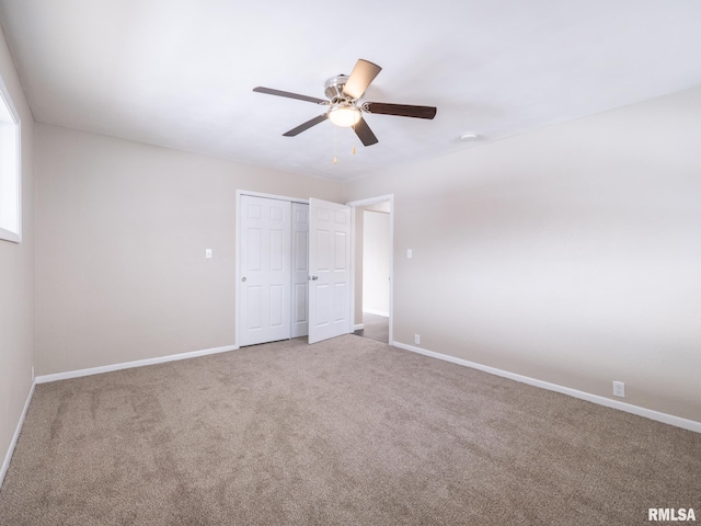 unfurnished bedroom with ceiling fan, a closet, and carpet floors