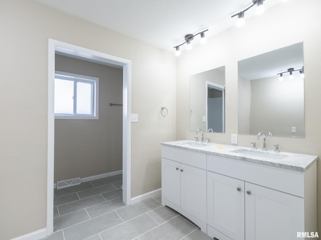 bathroom with tile patterned floors and vanity