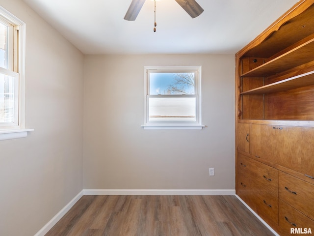 empty room featuring ceiling fan and dark hardwood / wood-style flooring