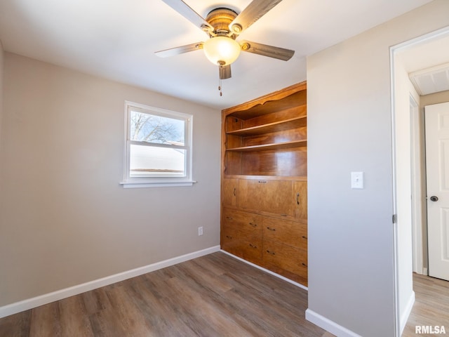 unfurnished room with hardwood / wood-style flooring and ceiling fan