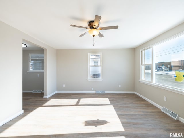 unfurnished room with hardwood / wood-style floors and ceiling fan