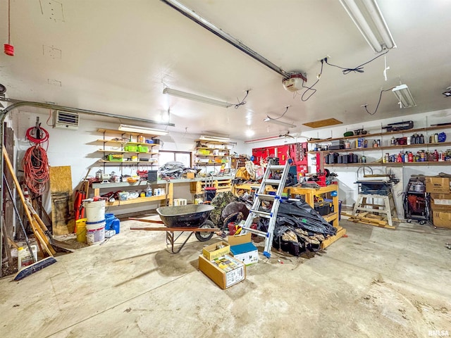 garage with a garage door opener and a workshop area