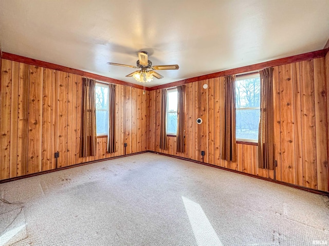 carpeted spare room with ceiling fan