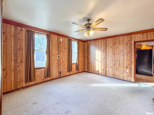 unfurnished living room featuring light colored carpet and ceiling fan