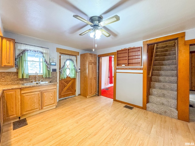 kitchen featuring sink, light hardwood / wood-style floors, and ceiling fan