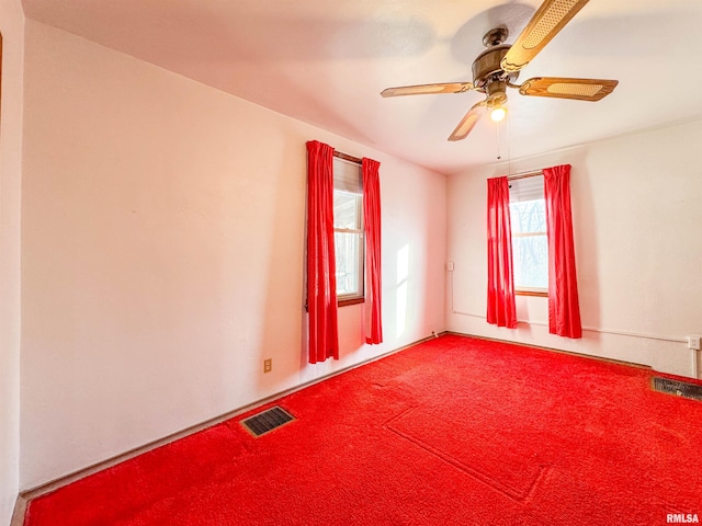 spare room with ceiling fan and carpet