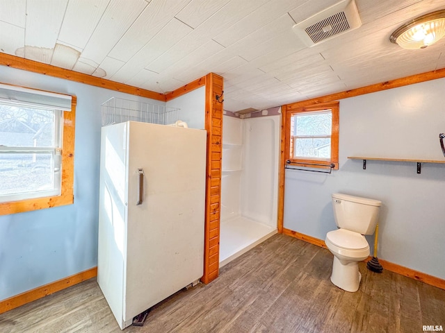 bathroom with plenty of natural light, hardwood / wood-style floors, wooden ceiling, and toilet