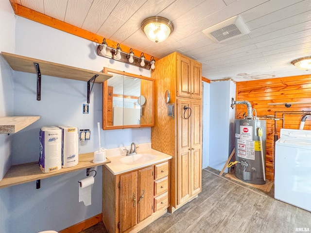 bathroom with washer / clothes dryer, hardwood / wood-style flooring, gas water heater, and wooden ceiling