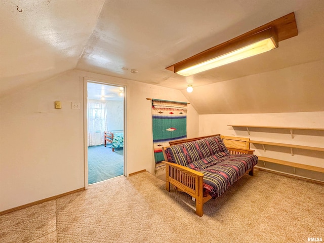 living area with lofted ceiling and carpet flooring