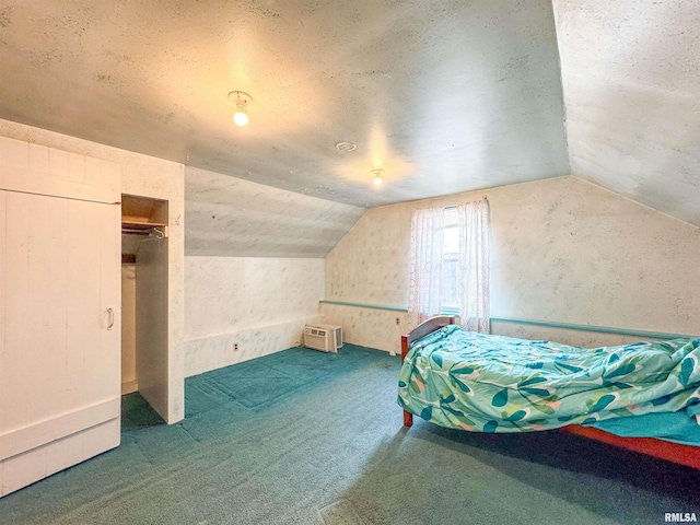 unfurnished bedroom featuring lofted ceiling, dark carpet, and a closet