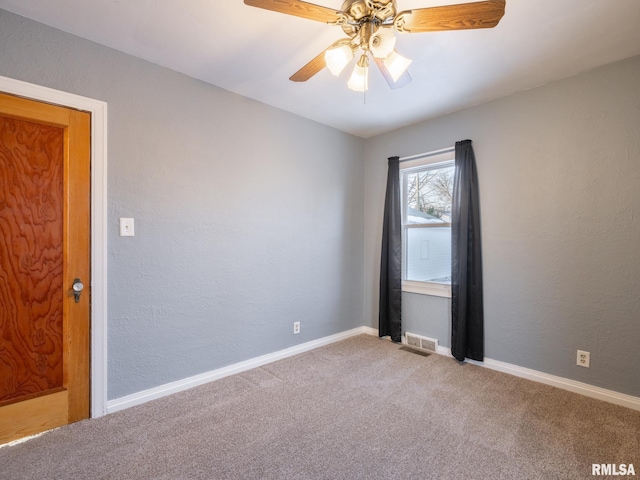 carpeted empty room featuring ceiling fan