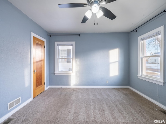 spare room featuring carpet floors and ceiling fan