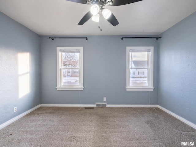 unfurnished room featuring ceiling fan and carpet flooring