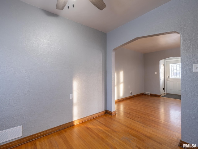 unfurnished room featuring ceiling fan and hardwood / wood-style floors