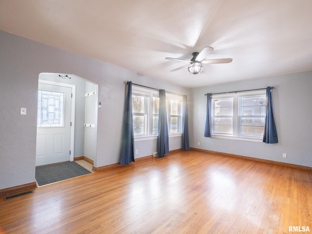 foyer with ceiling fan and light hardwood / wood-style flooring