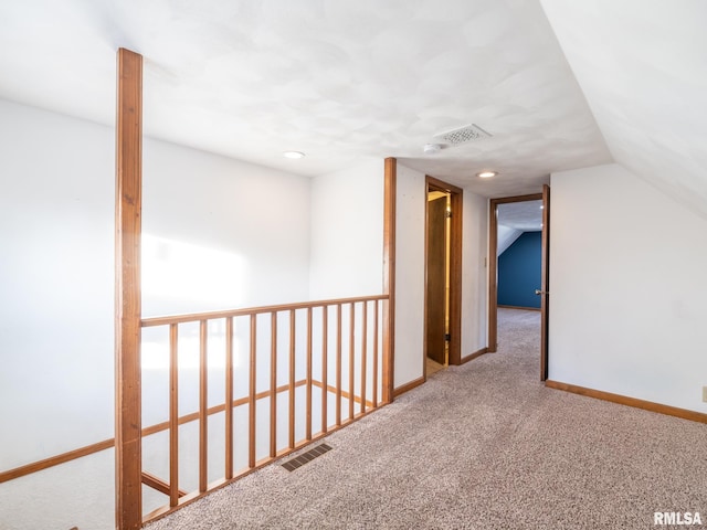 corridor featuring carpet flooring and lofted ceiling