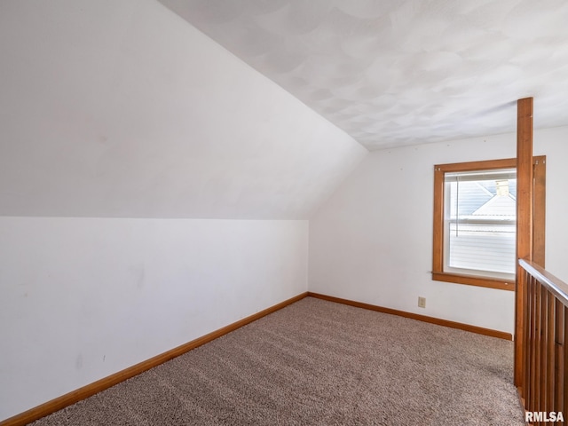 bonus room with carpet floors and lofted ceiling