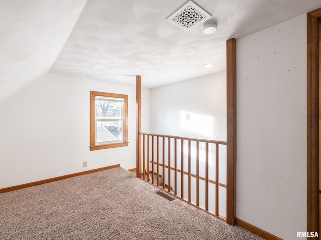 bonus room with lofted ceiling and carpet