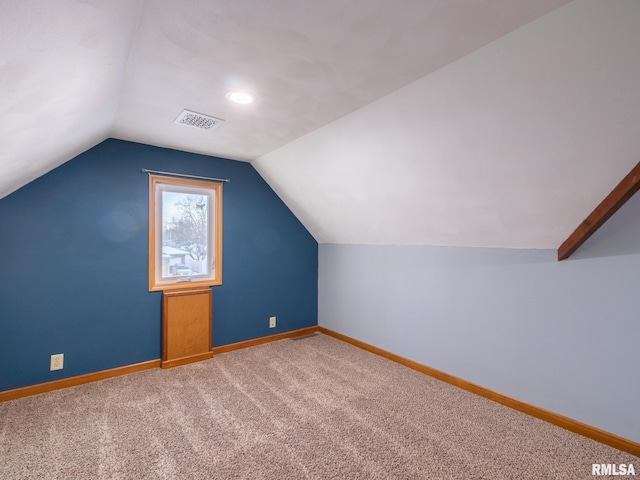 additional living space with carpet flooring and lofted ceiling