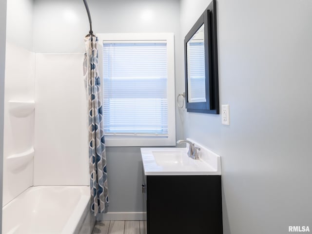 bathroom featuring vanity and shower / bathtub combination with curtain