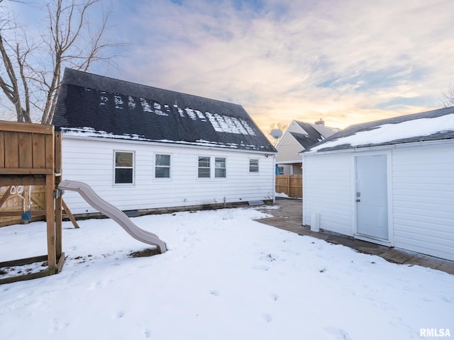 view of snow covered rear of property