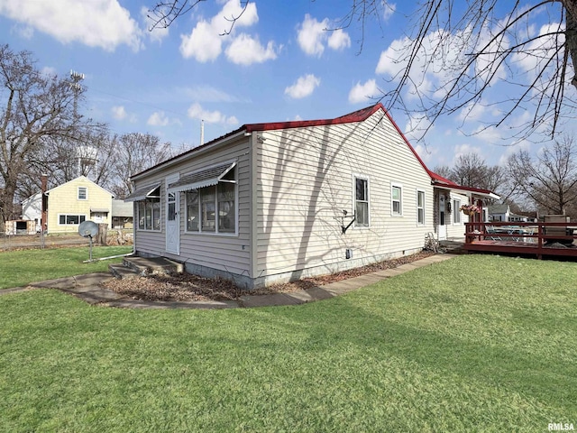 rear view of property with central air condition unit and a lawn