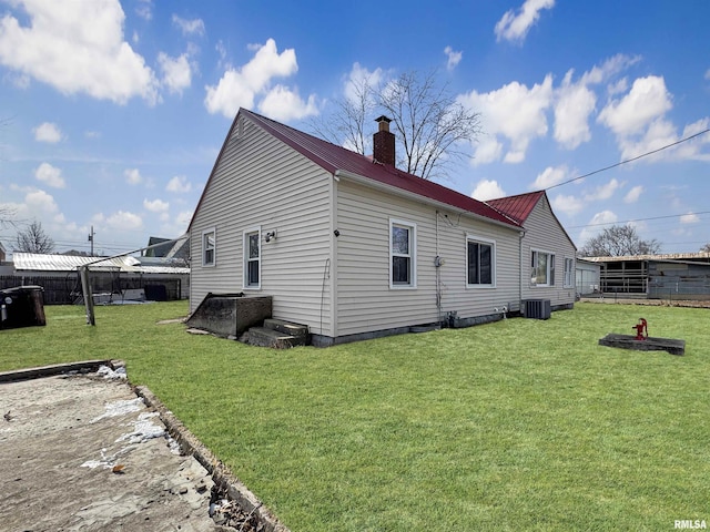 back of house with a wooden deck and a yard