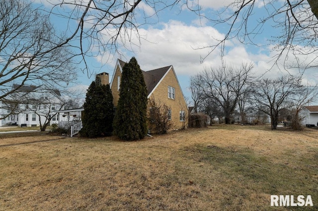 view of property exterior with a yard