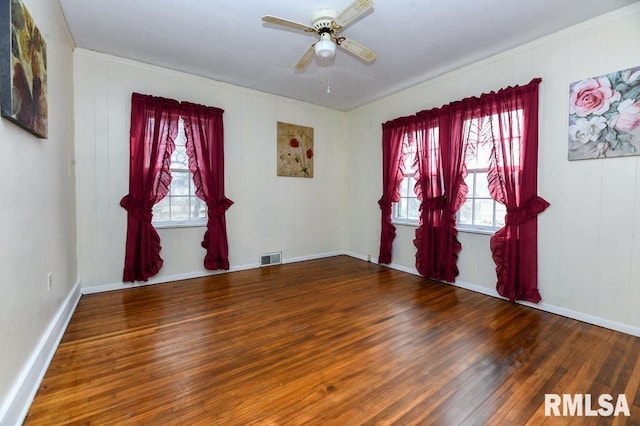 spare room with hardwood / wood-style floors and ceiling fan