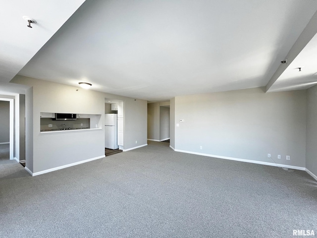 unfurnished living room featuring carpet flooring