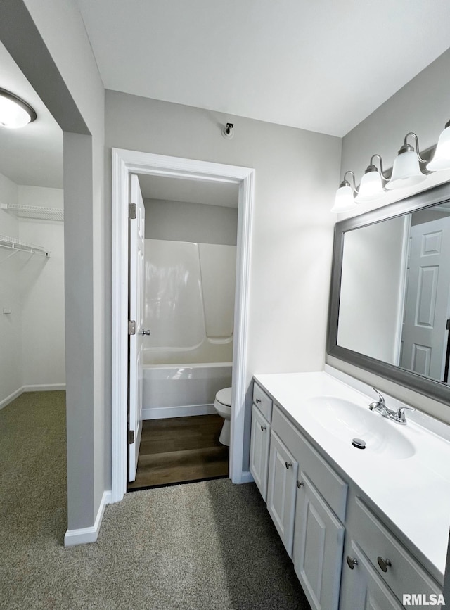 bathroom featuring toilet and vanity