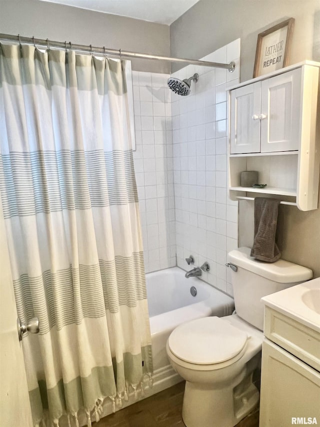 full bathroom featuring shower / bath combo with shower curtain, hardwood / wood-style floors, toilet, and vanity