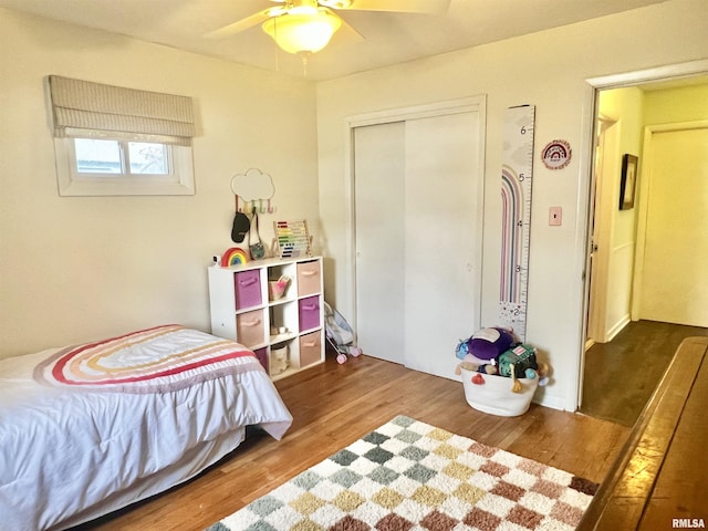 bedroom featuring hardwood / wood-style flooring, a closet, and ceiling fan