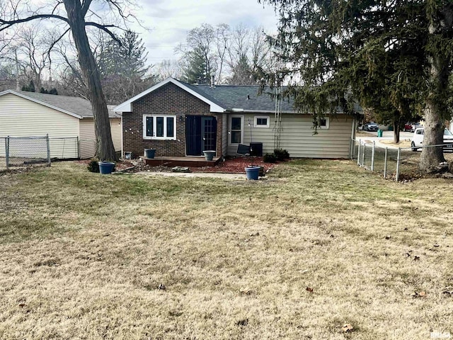 rear view of house with a yard