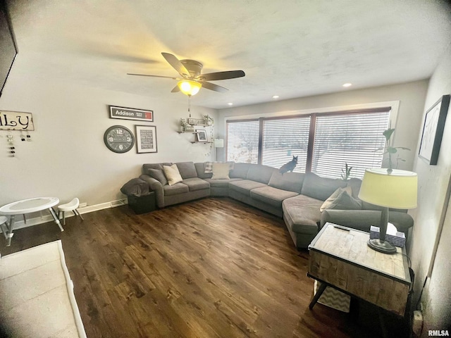 living room with ceiling fan and dark hardwood / wood-style flooring