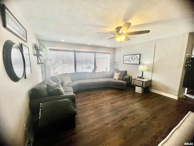 living room featuring dark hardwood / wood-style floors and ceiling fan