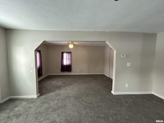 carpeted empty room featuring ceiling fan and a textured ceiling