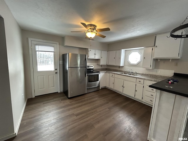 kitchen with sink, white cabinetry, stainless steel appliances, and a textured ceiling