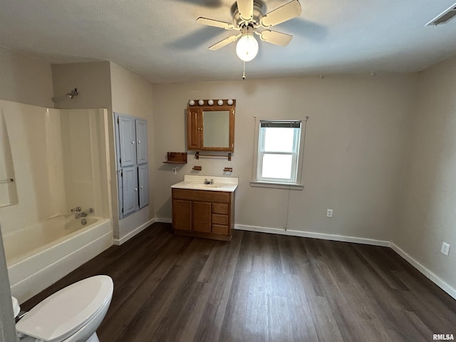 full bathroom featuring tub / shower combination, ceiling fan, hardwood / wood-style flooring, toilet, and vanity