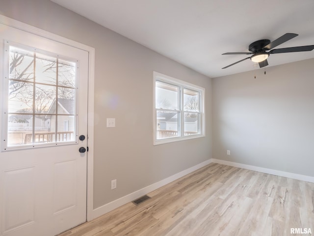 doorway featuring ceiling fan and light hardwood / wood-style flooring