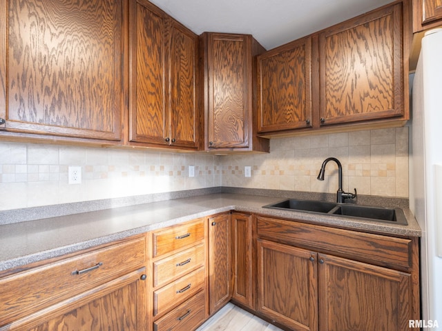 kitchen featuring sink and tasteful backsplash